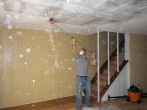 Tim is scraping the popcorn ceiling off. It was a huge mess, but we did it before we moved any furniture in.